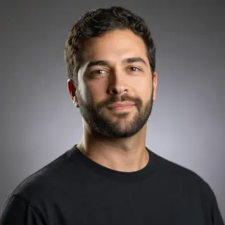 Reference professional headshot on a grey gradient background